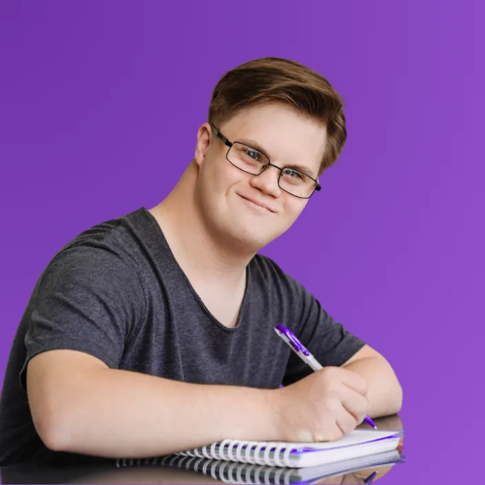 Young person writing with support